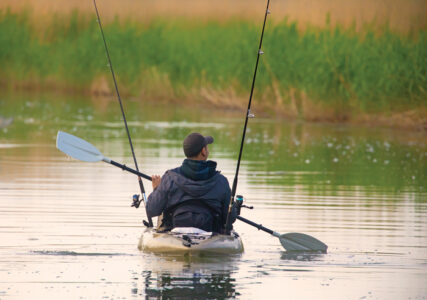 Fisherman in inflatable canoe